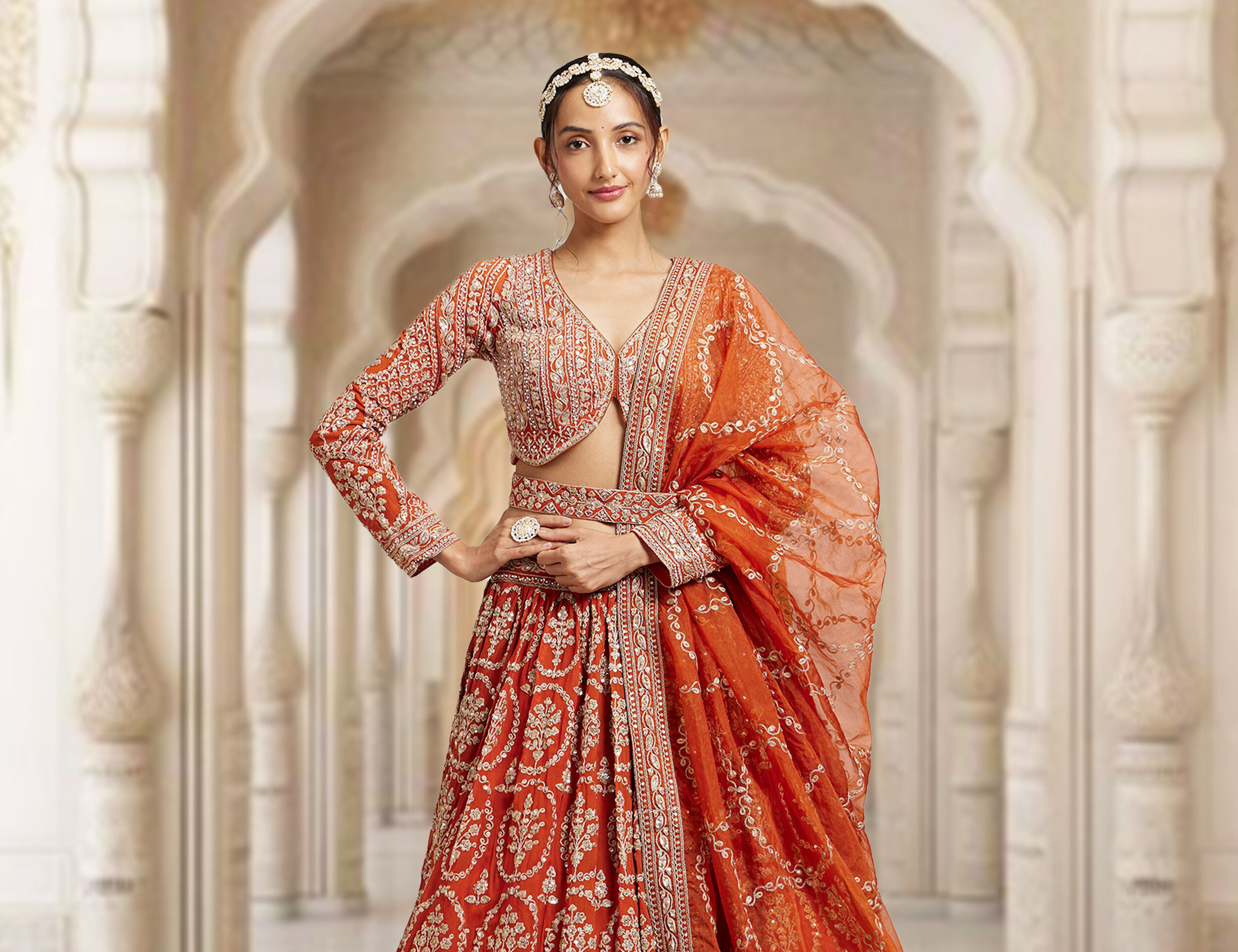 Trendy orange lehenga with a stylish matching blouse, a vibrant choice for a personalized bridal outfit
